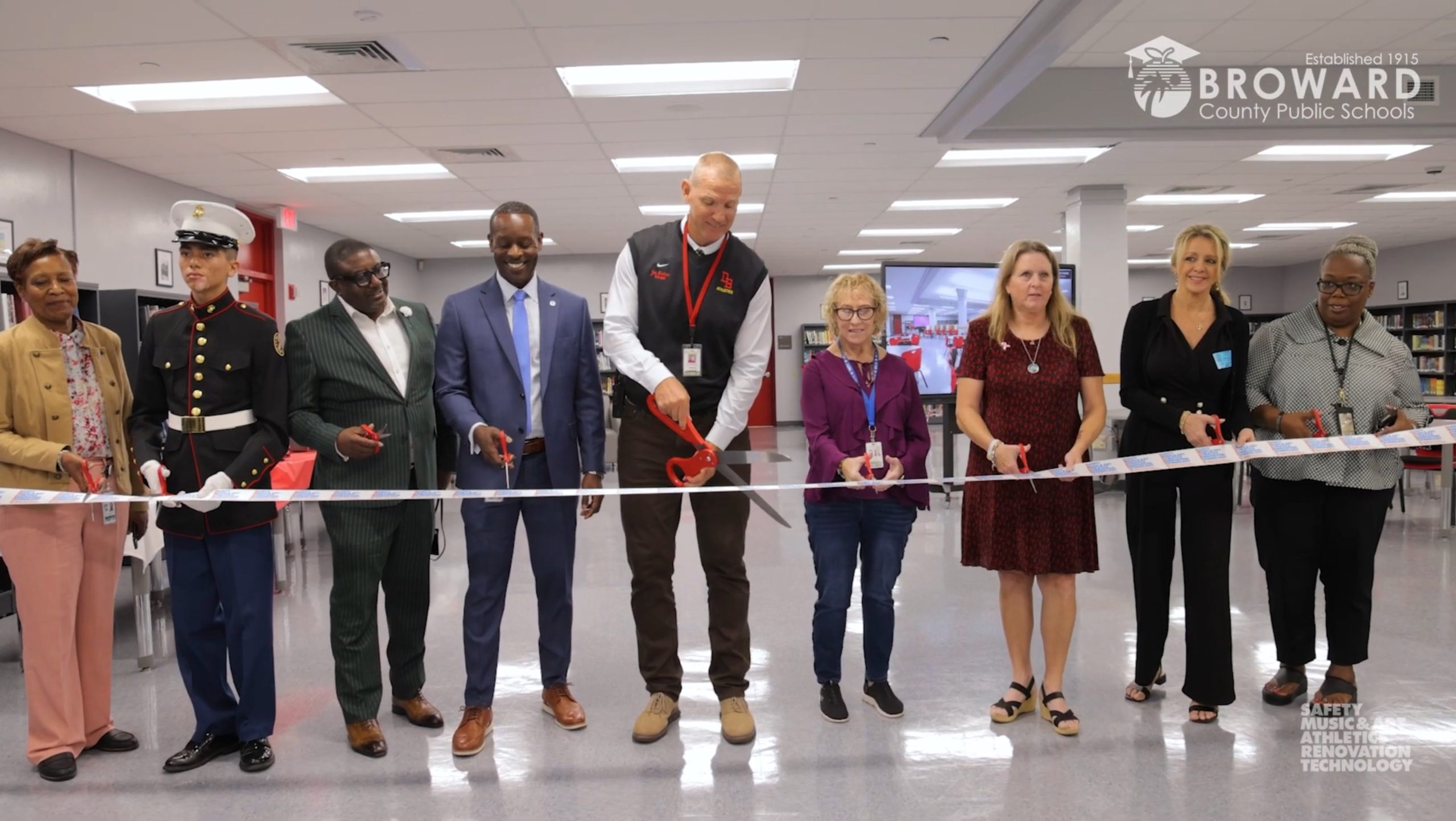 People cutting a ribbon