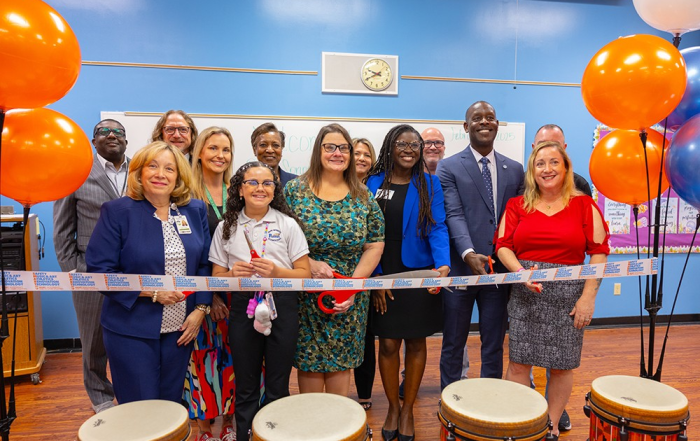 Ribbon cutting group of students and teachers