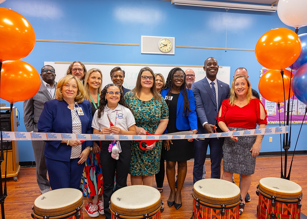 Ribbon cutting group of students and teachers