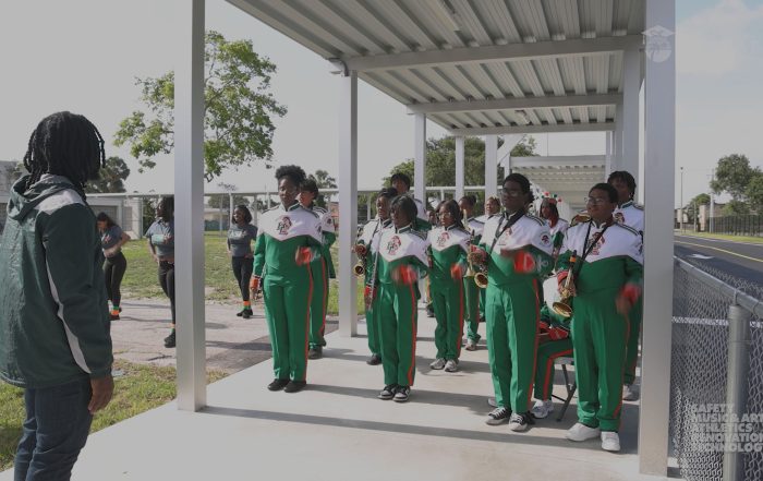 School band in a group setting for a ribbon cutting ceremony